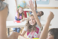 Raising Hands in school class - Literacy crisis is second reason why teach my baby to read - because it will give your child lifelong benefits