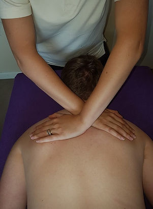 Client receiving myofascial release over the shoulder blades