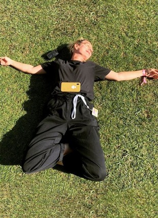 women lying on a field of grass in the sunshine in France