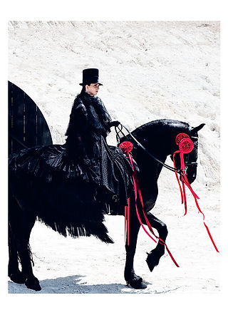Female model wearing couture fashion by Cunnington & Sanderson riding a horse for Creed perfume Aventus for Her international campaign