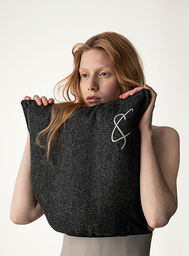 Portrait photography of a female model wearing the original pillow top by Cunnington & Sanderson before the pillow challange