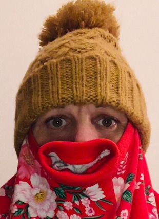 garment smile with a sweater and a wool knitted hat