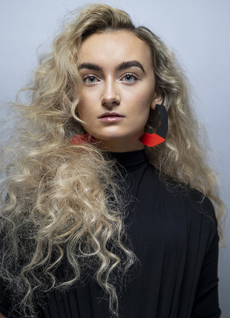 Model with blonde hair and black dress promoting inclusivity and diversity for Zebedee Agency