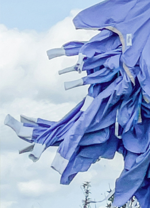 luxury fashion emotive storytelling style ppe gown dress blowing in the wind