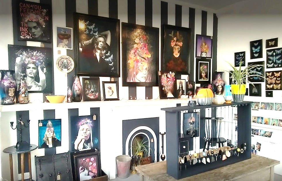 Art gallery with floral-themed portraits on black and white striped walls. Vibrant decor includes paintings, vases, and plants.
