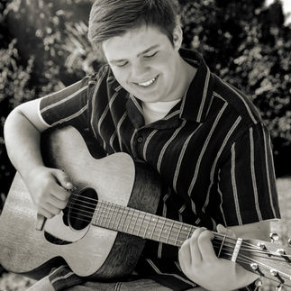 © Donnavon Evans - Portrait of Young Man Playing Guitar