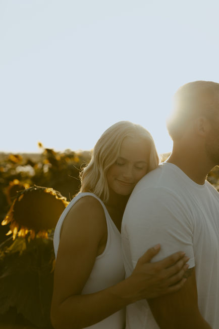 Girlfriend rests head on boyfriend's shoulder.