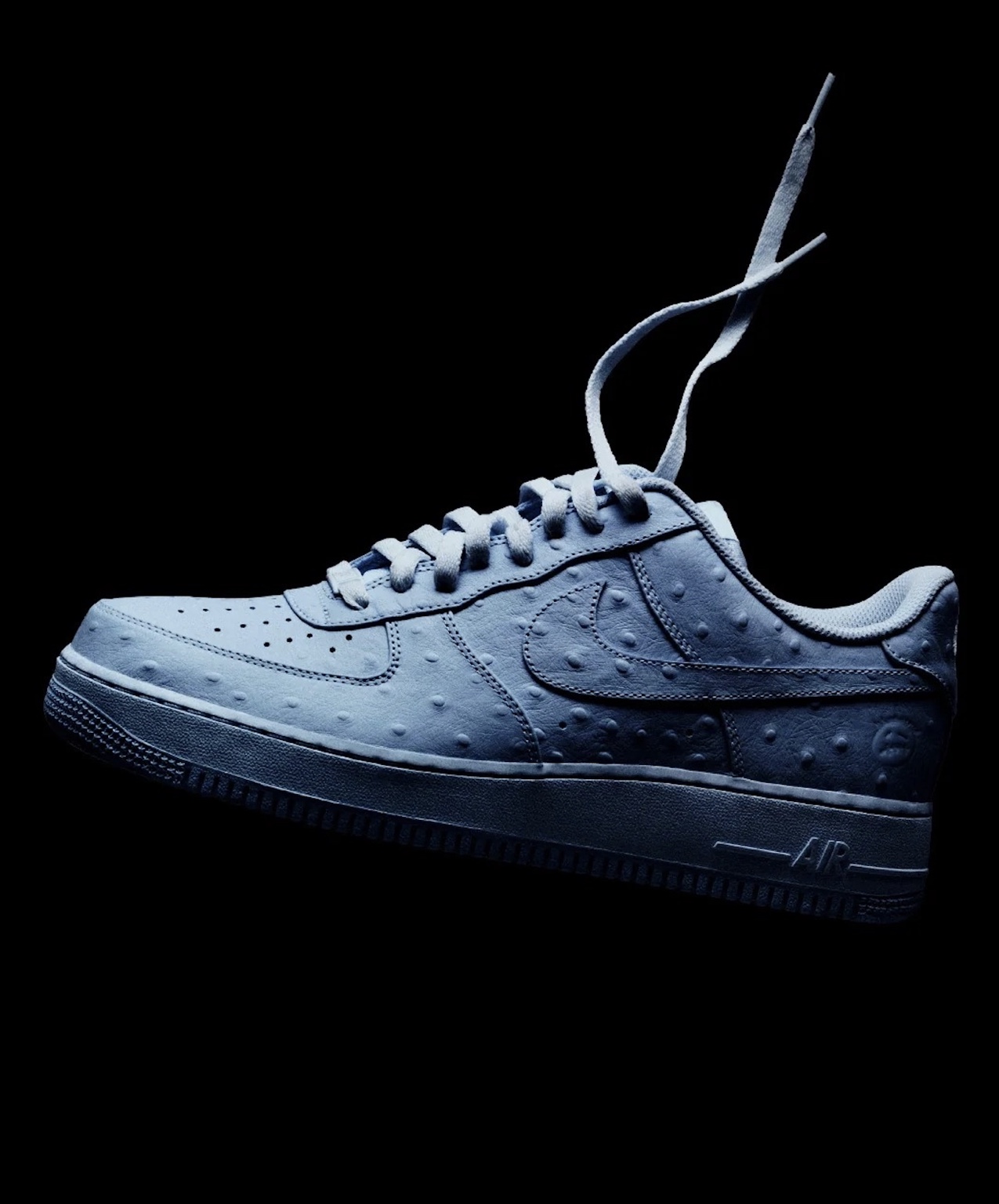 Nike × Cactus Jack ice-blue Air Force 1 against a black background