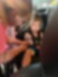 Child Getting Fitted for Car Seat