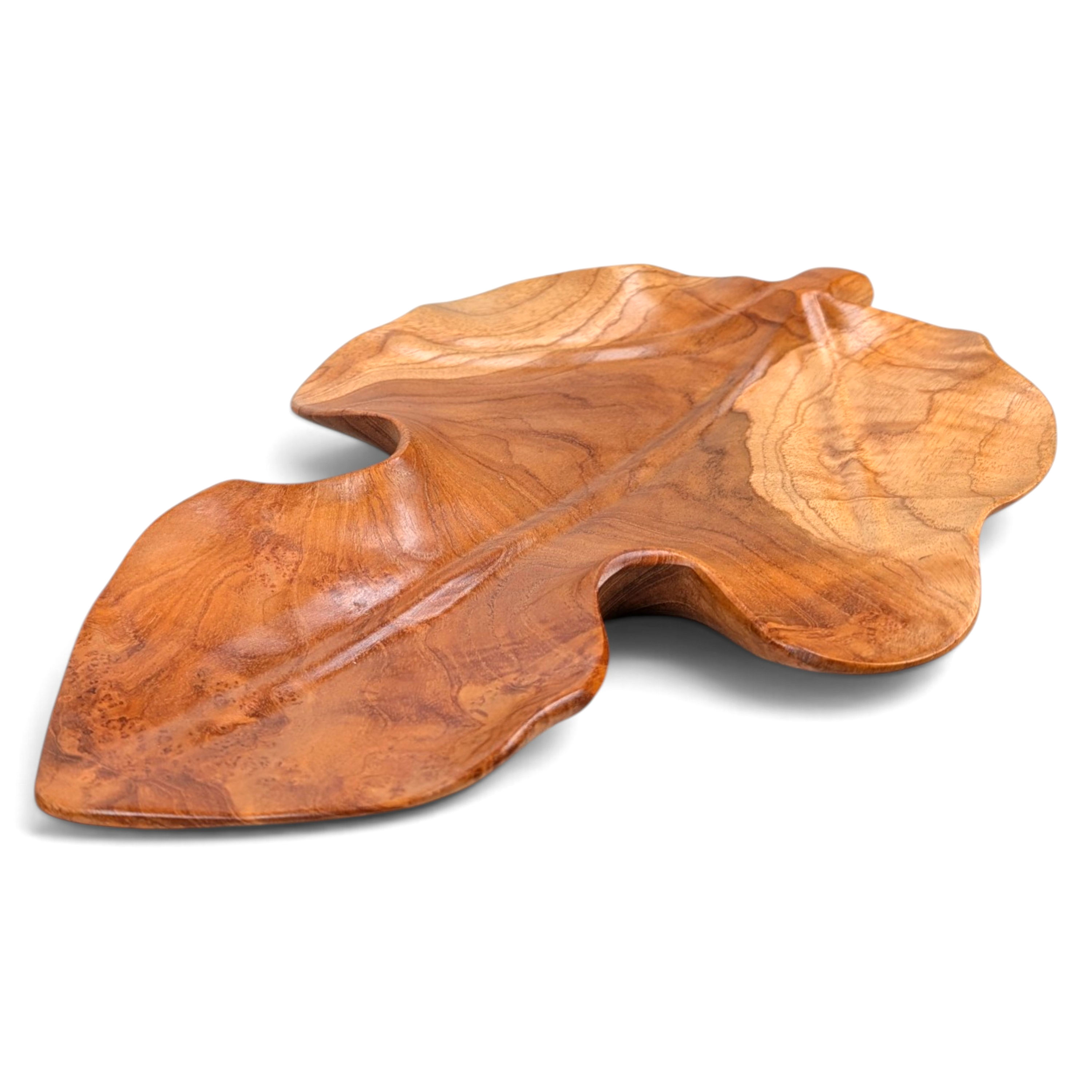 Artisan-carved teak leaf decorative piece with natural wood grain