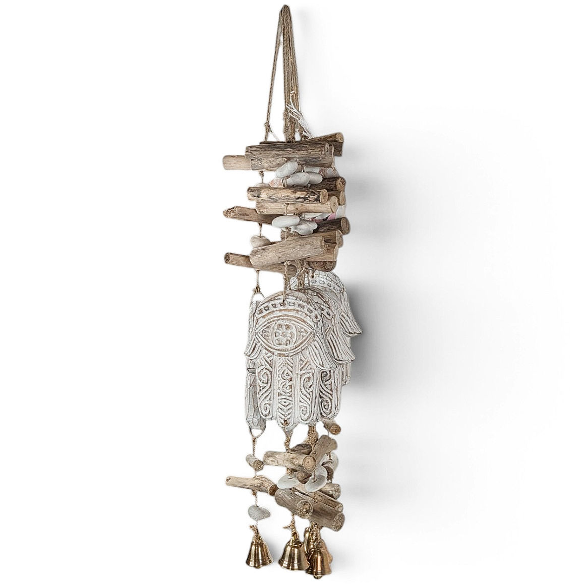 White Hamsa wall hanging with etched eye pattern and driftwood logs.