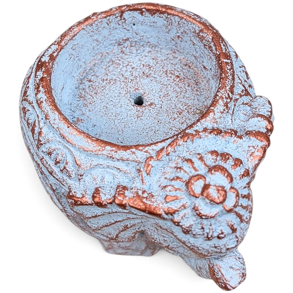 Thumbnail: Boho style cement elephant sculpture holding a lit incense cone on a shelf.