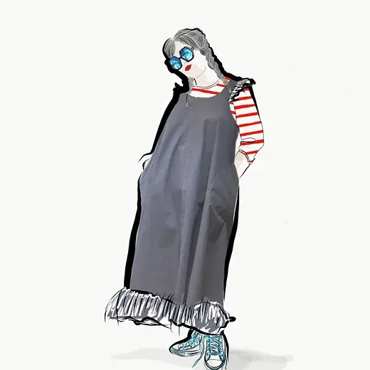 woman posing in a smock dress with frills around sleeve edge and hem, breton stripe long sleeve tshirt and gym shoes 
