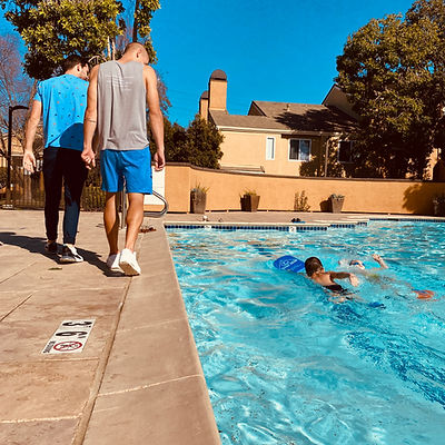 Two swimming coaches given a private swimming lesson at the community pool