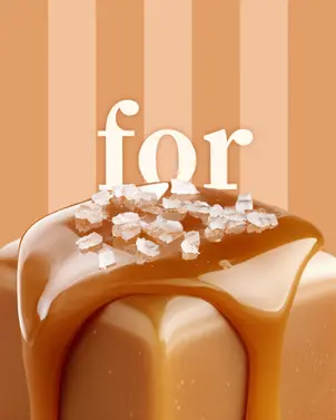 Caramel sauce dripping over a salted caramel square with sea salt crystals against a brown striped background featuring the word "for".