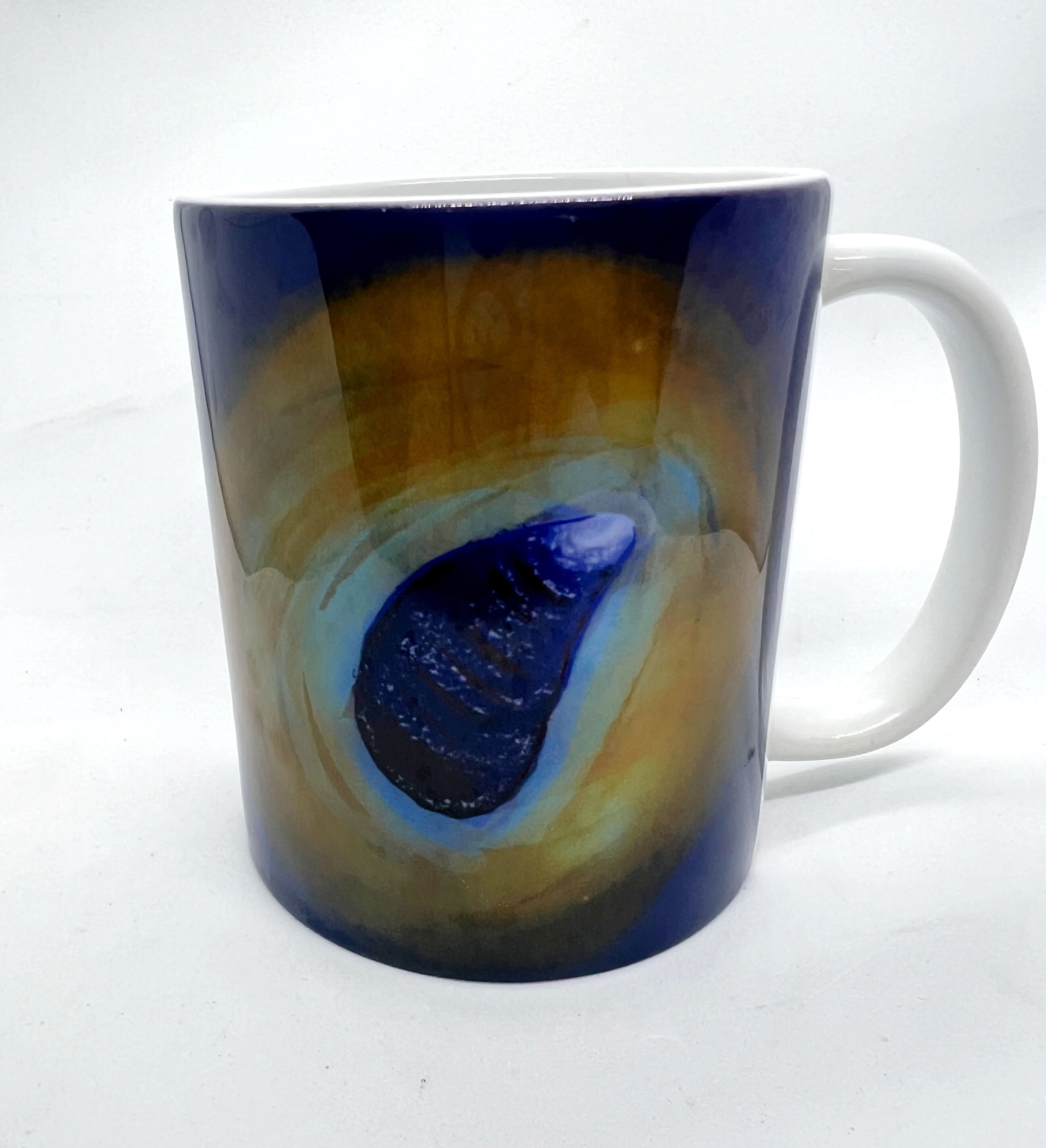 Mug showing sea shell on purple and gold background. Image copyrite KJW