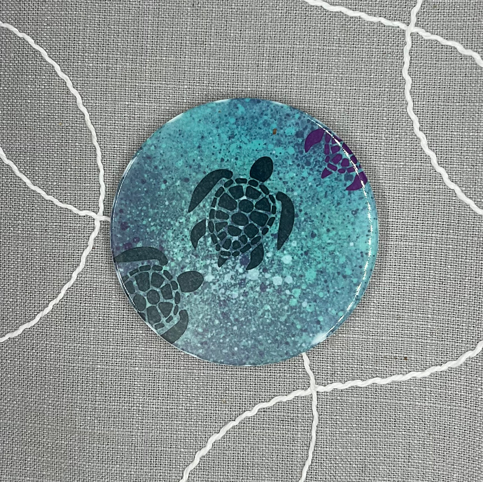 Ceramic placemat coaster with a blue and teal representation of a blue turtle swimming in the sea