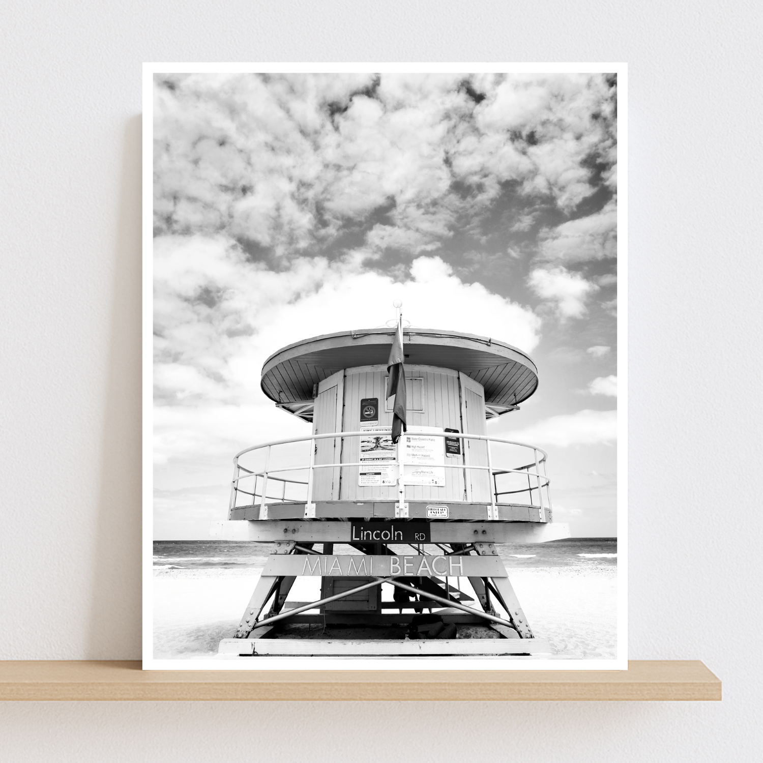 Black and white vertical photo of an Art Deco lifeguard stand on Miami Beach with a cloudy sky.