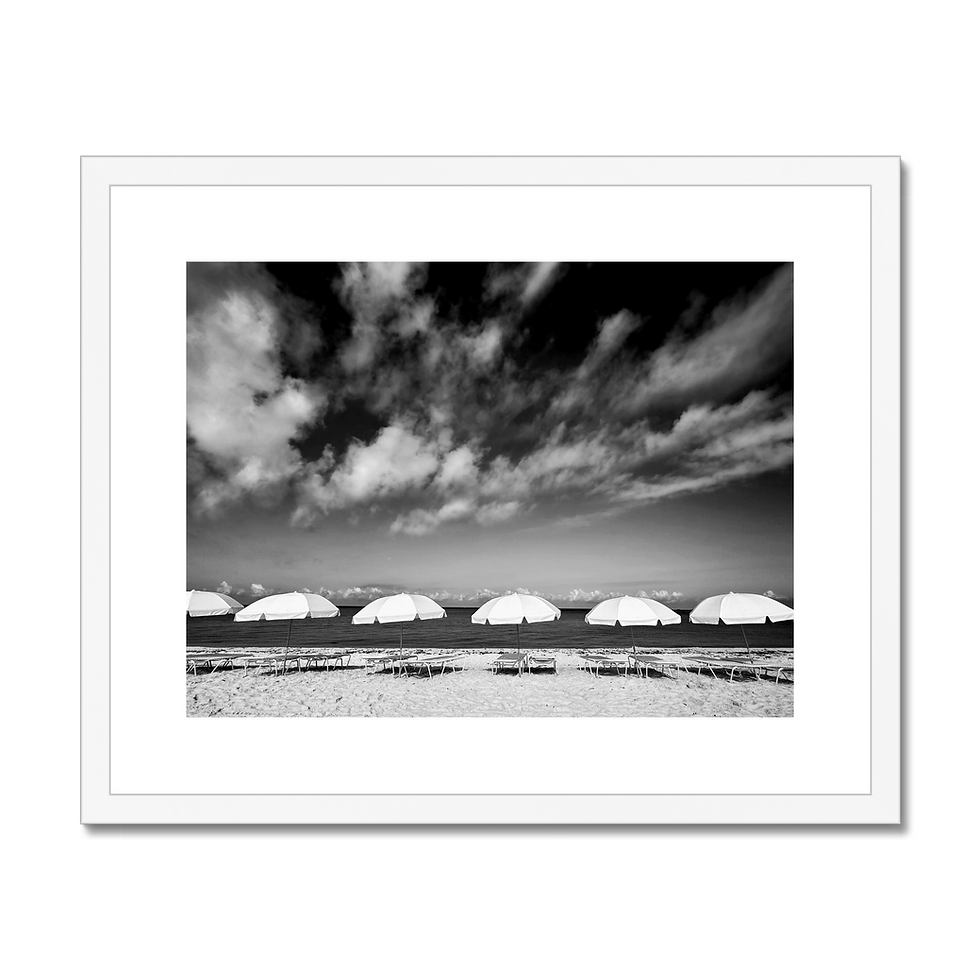 Thumbnail: Black and white minimalist photo print of parasols lined up on beach with clouds