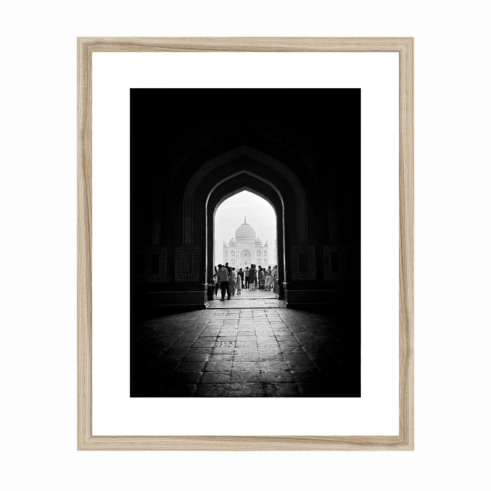 Thumbnail: Vertical black and white photo of the Taj Mahal framed through a dark, arched entryway in Agra.
