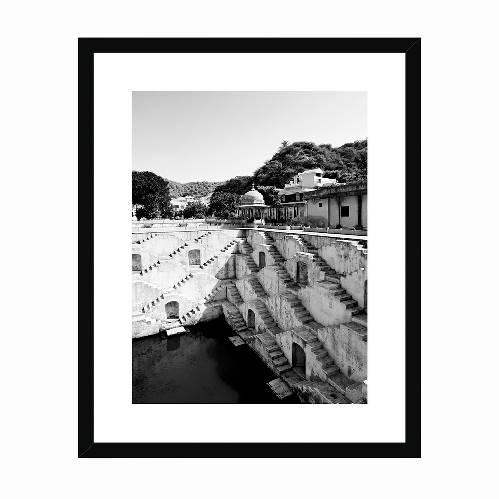 Vertical black and white photo of Panna Meena ka Kund stepwell basin and pavilion in Jaipur.