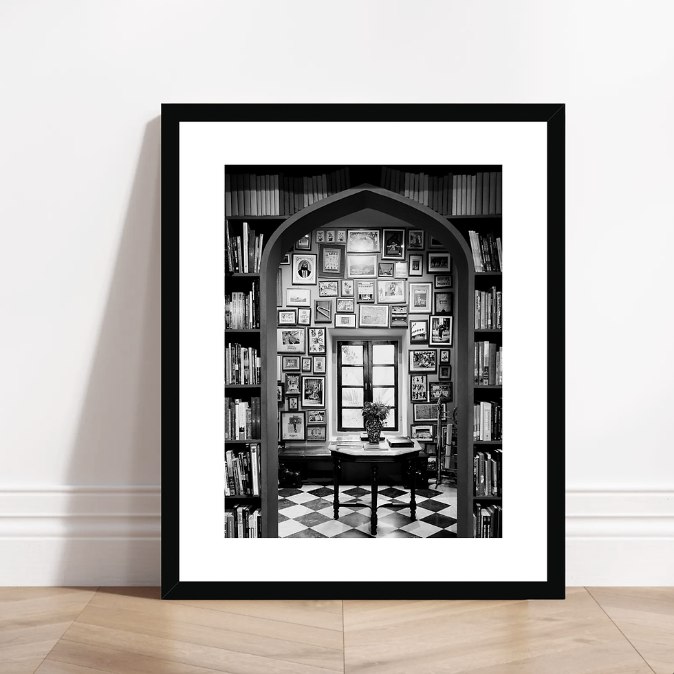 Thumbnail: Vertical black and white photo of an arched doorway looking into a library at Jaipur City Palace.
