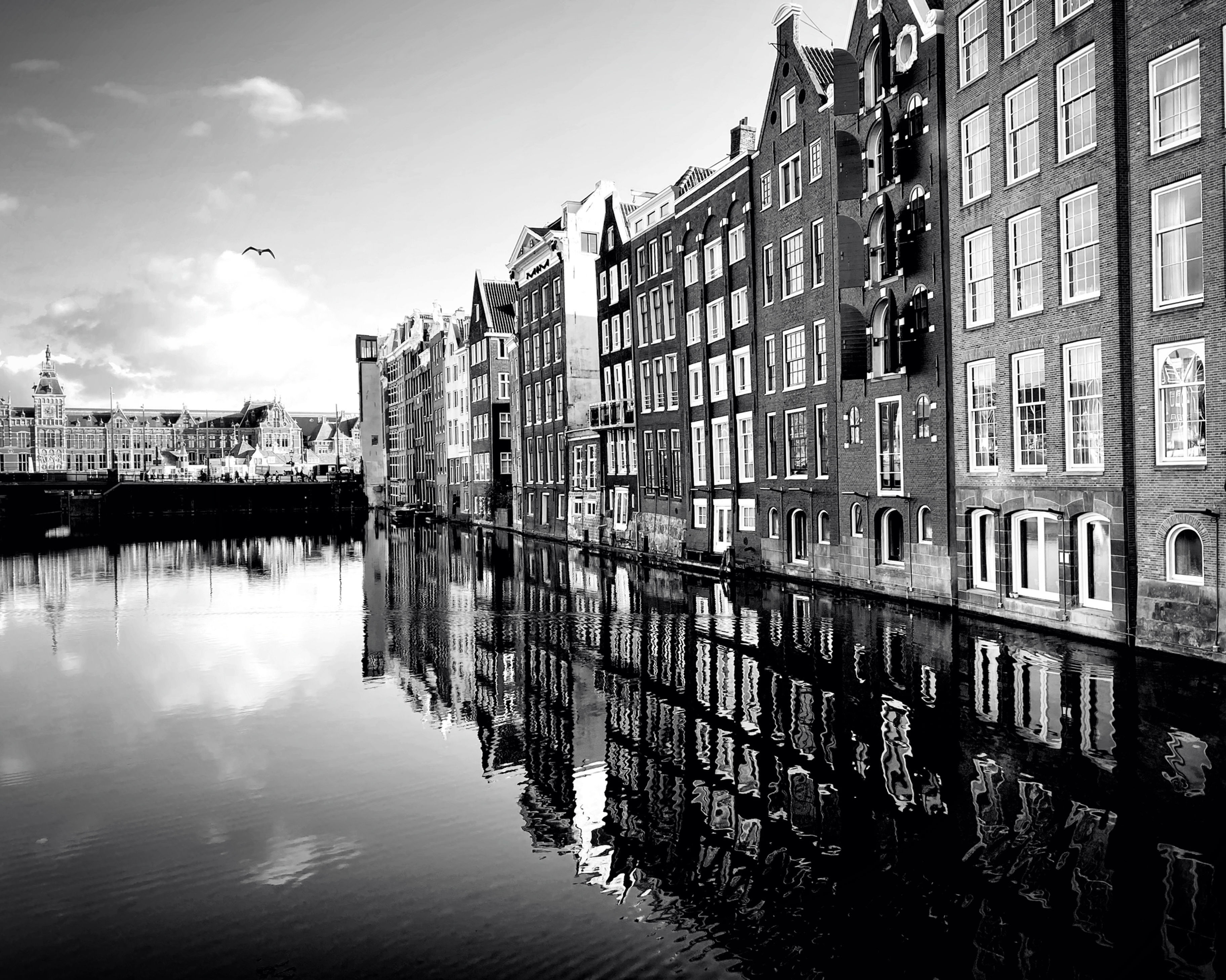 Black and white photo print of Damrak canal of reflection near Central Station in Amsterdam, Netherlands