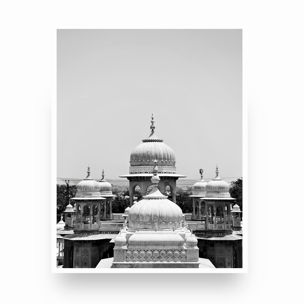 Vertical black and white photo of stacked marble chhatri domes at Gaitor Ki Chhatriyan in Jaipur.