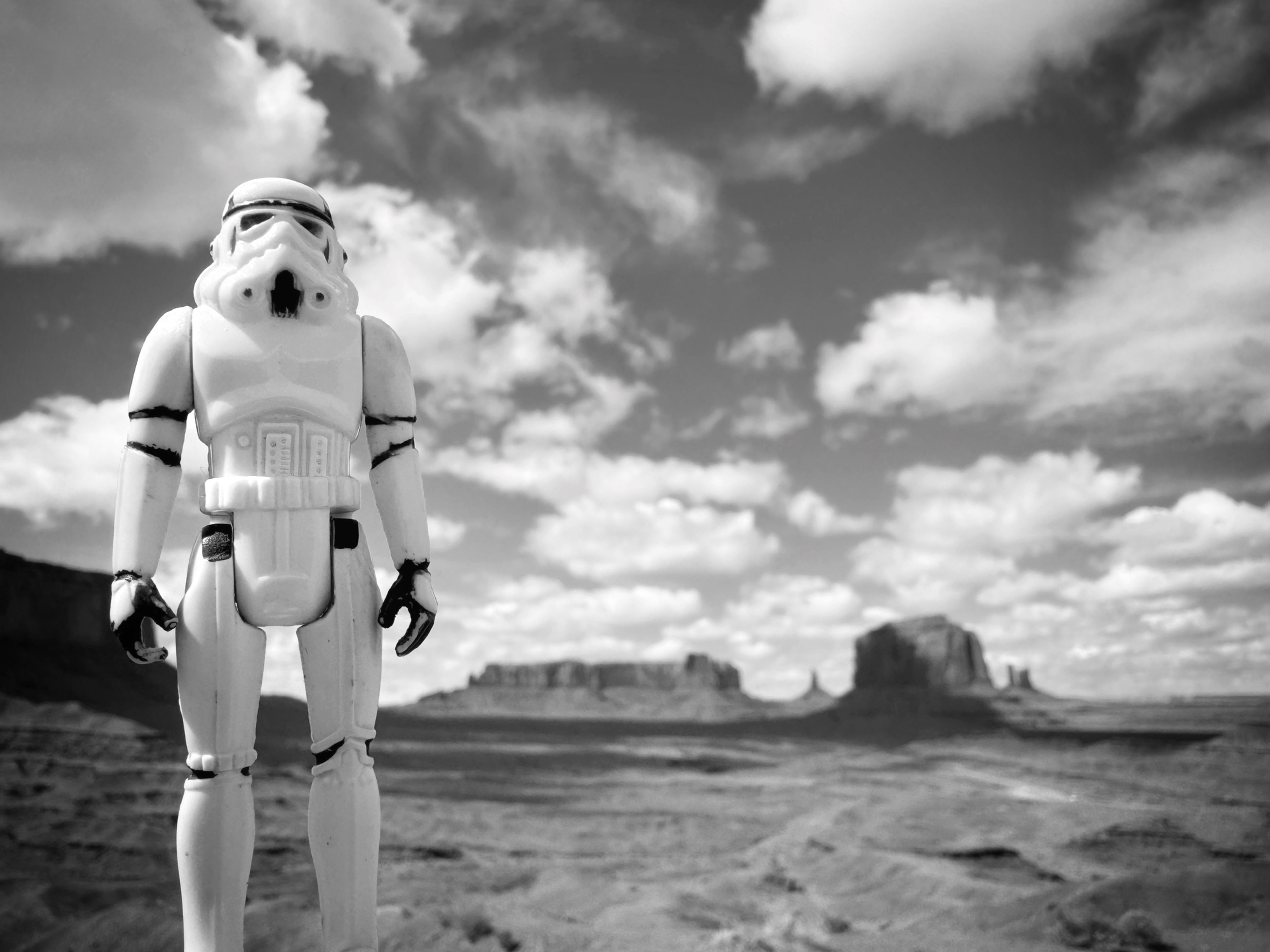 Black and white photo print of 1977 Star Wars Stormtrooper action figure in Monument Valley, Arizona with sky