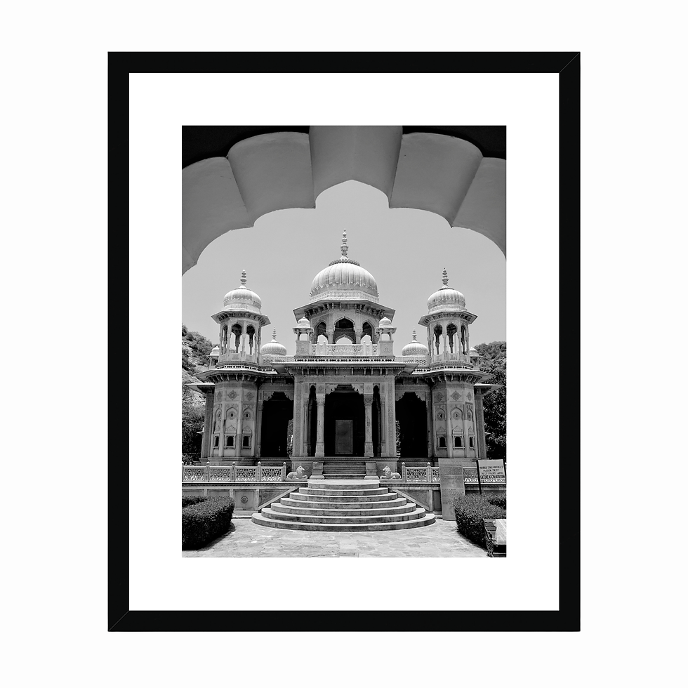 Vertical black and white photo of a grand marble pavilion framed through an arch at Gaitor in Jaipur.