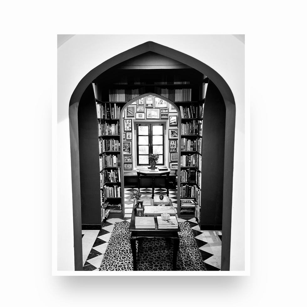 Vertical black and white photo looking through nested archways into a bookstore at Jaipur City Palace.