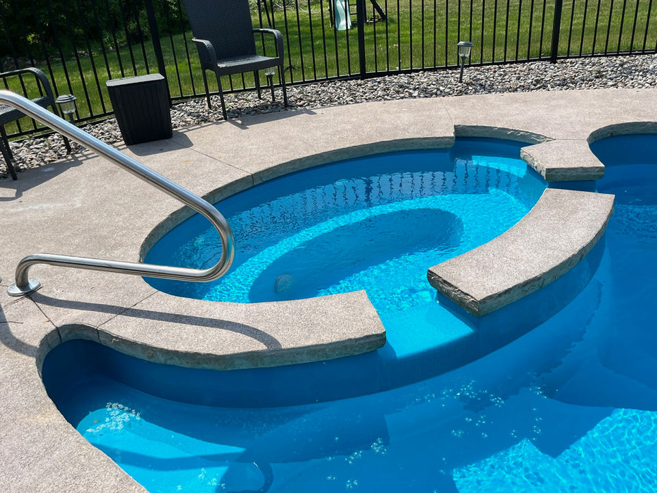 Concrete spa surround and view of spa area.