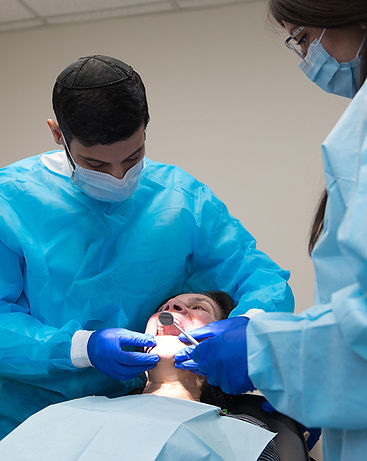 Dr. Kuyunov providing dental implants to a Rochester, NY, patient.