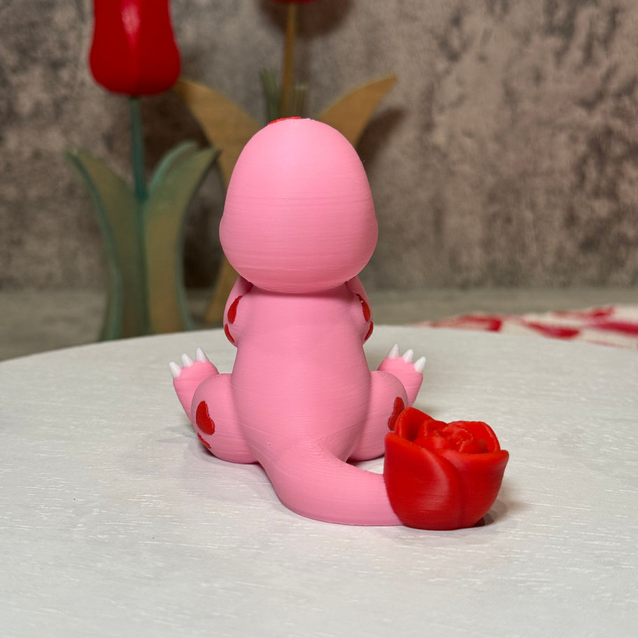 Pink Charmander with heart eyes, fangs, and a rose tail, sitting sweetly with its head resting on its hands.