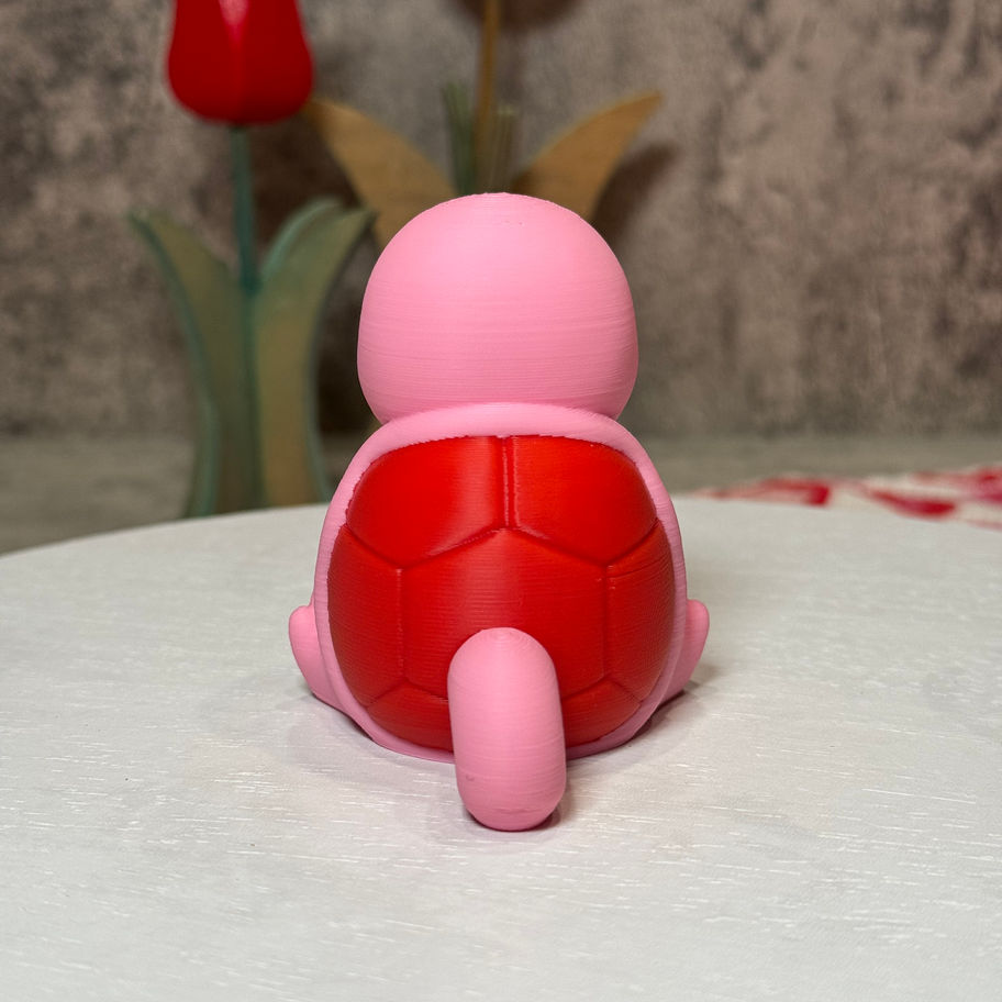 Got it! Here's the corrected alt text:  **Smiling pink Squirtle holding a red rose—adorably chill and full of Valentine vibes