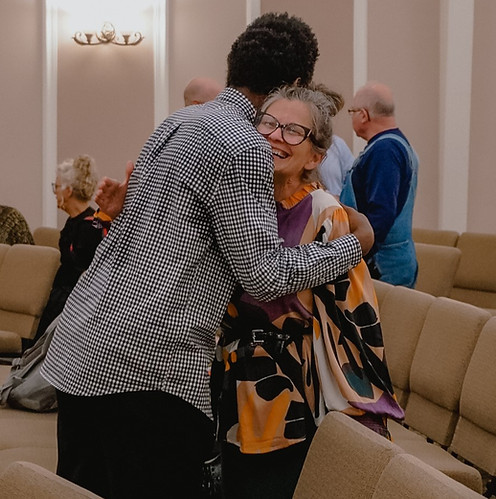 two people hugging and smiling