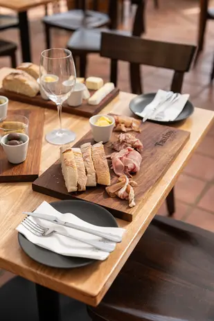 Hospitality brand photography featuring a styled charcuterie table and wine glasses.