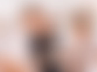 Three adults standing outdoors reviewing restaurant options on their smartphones before choosing where to dine in a coastal town.