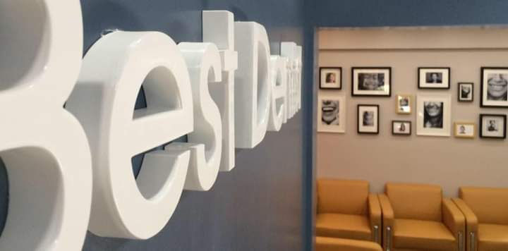 Eye-level view of a modern dental clinic reception area in Al Rigga