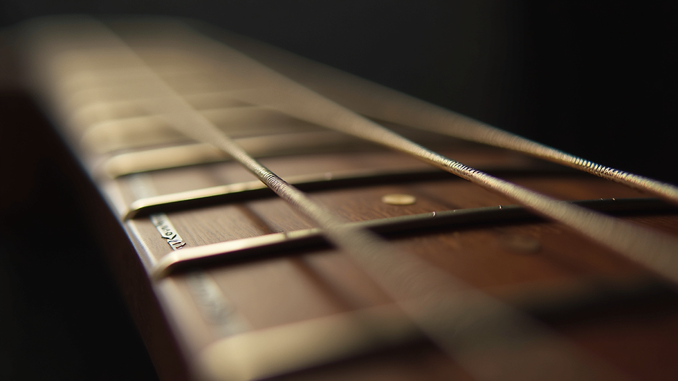 Eye-level view of a guitar fretboard with chord diagrams