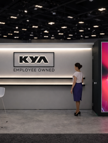 KYA Employee Owned booth with staff and seating