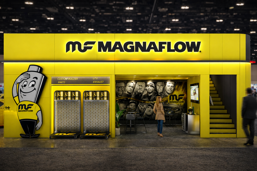 MagnaFlow yellow exhibit design with mascot and staircase