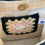 Thumbnail: view of inside pockets of Charming 100% cotton crochet bag.  Perfect for any occasion! 
 Square pattern: Antique pink, white,  beige and black.
Bamboo handles.  Inside pocket and internal magnetic snaps.
It measures 8 x 8 in.   At Lapin Curiosities.