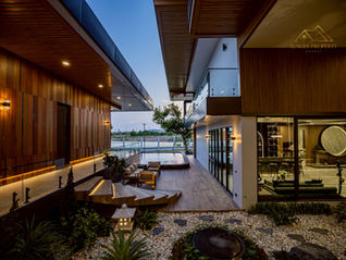 Exterior view of a grand estate featuring a large private swimming pool and scenic views of Chaknok Lake, highlighting the premium lifestyle of these ultra luxury villas for sale Pattaya.