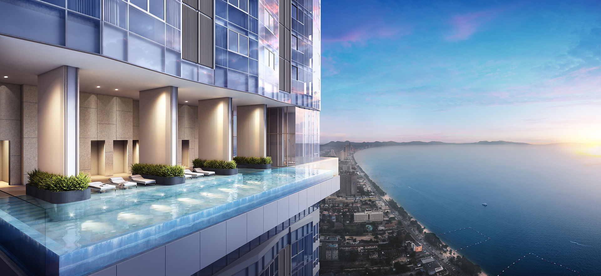 High-altitude cantilevered infinity edge swimming pool with glass railings overlooking panoramic sea views at Skypark Lucean Jomtien Pattaya.