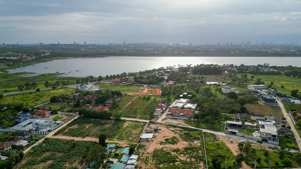 Aerial view of luxury housing developments and land plots near Mabprachan Lake with Pattaya skyline in background