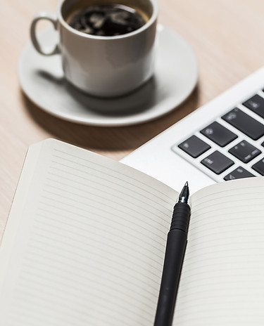 writing-in-a-notebook-next-to-a-cup-of-coffee-and-2025-02-25-22-47-50-utc.jpg