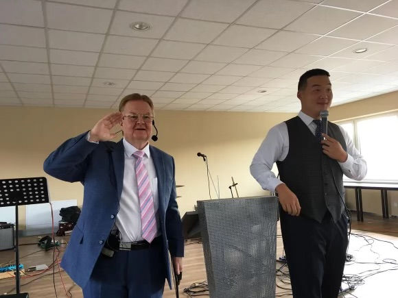 Pastor Alan Carlin preaching with his translator