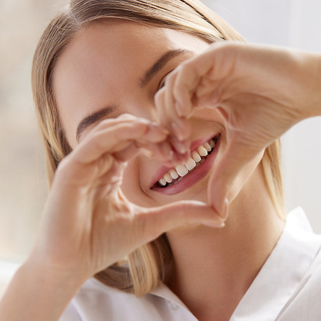 Smiling Woman Showing Heart Sign with Hands