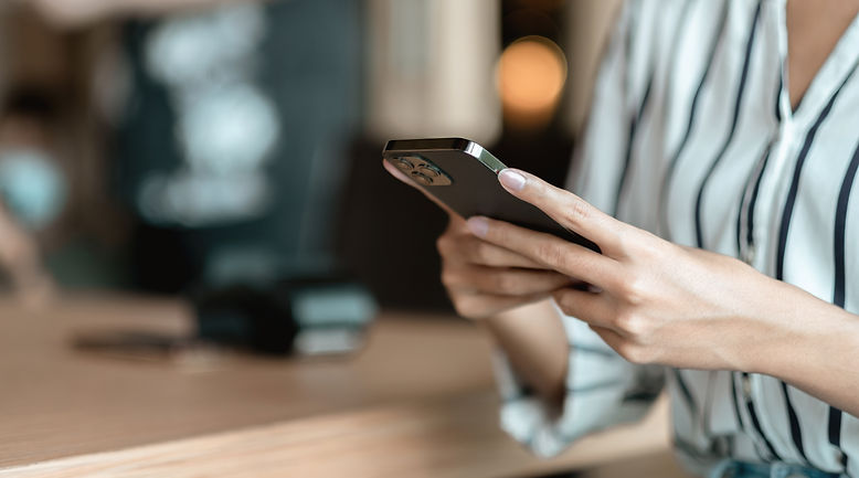 hand of woman using smartphone